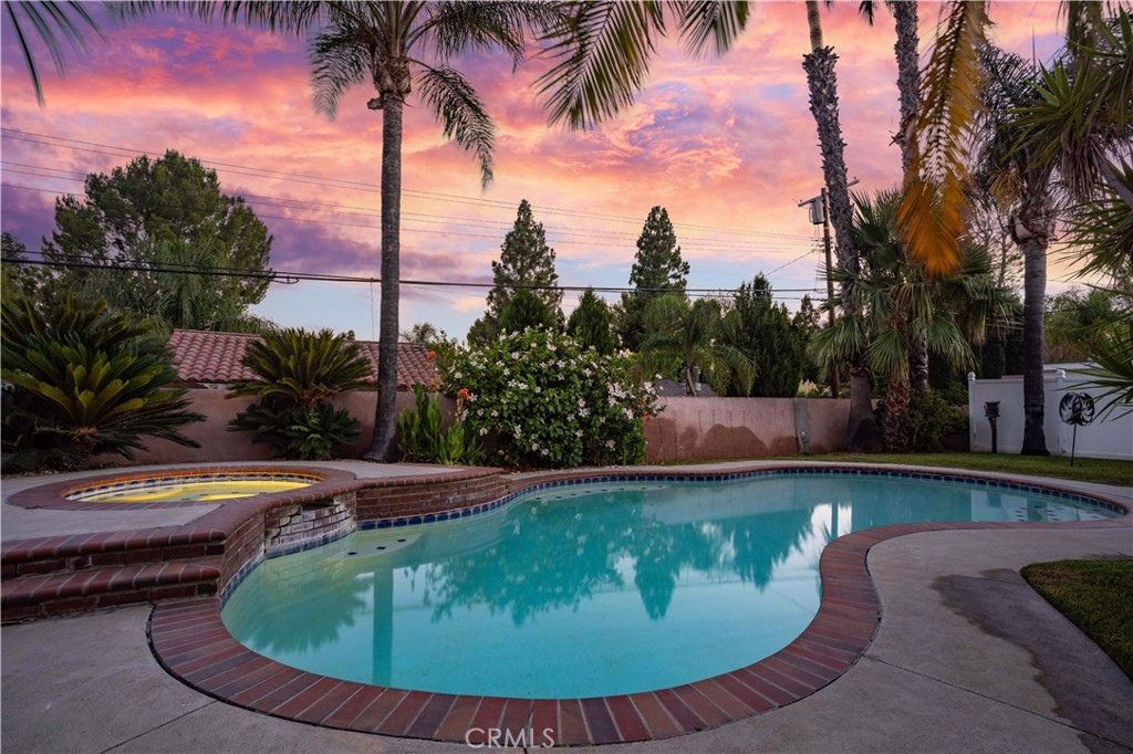 18308 Lahey Street Porter Ranch, CA 91326 - Photo 38 of 41 a view of a swimming pool with a yard and trees