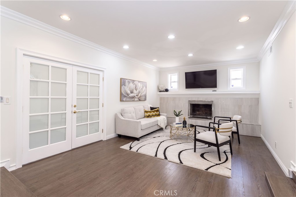 18308 Lahey Street Porter Ranch, CA 91326 - Photo 4 of 41 a living room with furniture a fireplace and a flat screen tv
