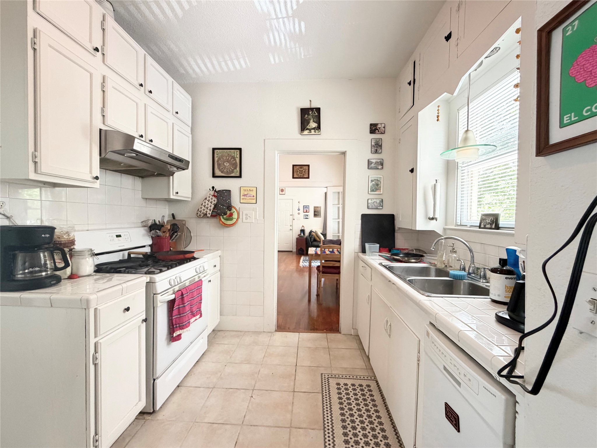 404 West 43rd Street, Unit A Austin, TX 78751 - Photo 6 of 10 a kitchen with stainless steel appliances granite countertop a stove sink and cabinets