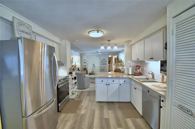 a kitchen with a table chairs and a chandelier