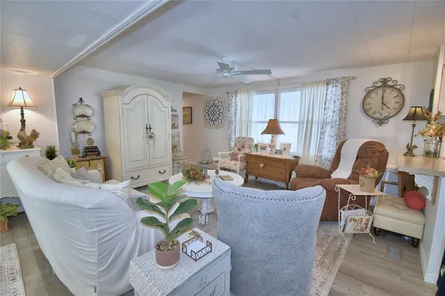 a living room with furniture a dining table and a chandelier