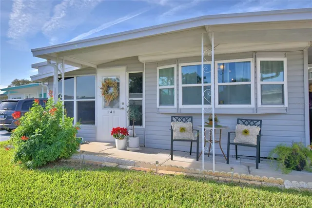a front view of house with outdoor seating and yard