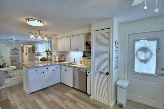 a kitchen with stainless steel appliances a refrigerator sink and cabinets