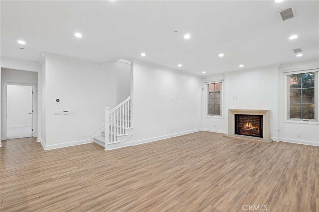 40 Lupari Irvine, CA 92618 - Photo 12 of 56 a view of an empty room with wooden floor fireplace and a window