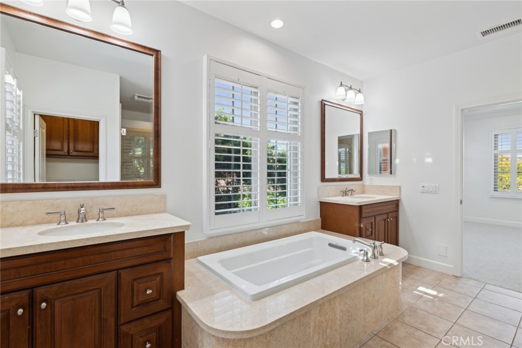 40 Lupari Irvine, CA 92618 - Photo 18 of 56 a spacious bathroom with a tub a sink and mirror