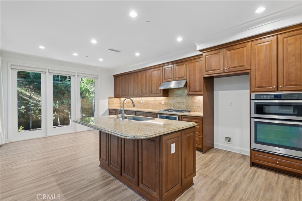 40 Lupari Irvine, CA 92618 - Photo 6 of 56 a kitchen with a sink stove and wooden cabinets