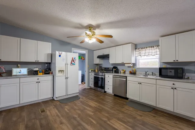 a kitchen with refrigerator a sink and cabinets
