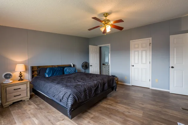 a bedroom with a large bed and a chandelier