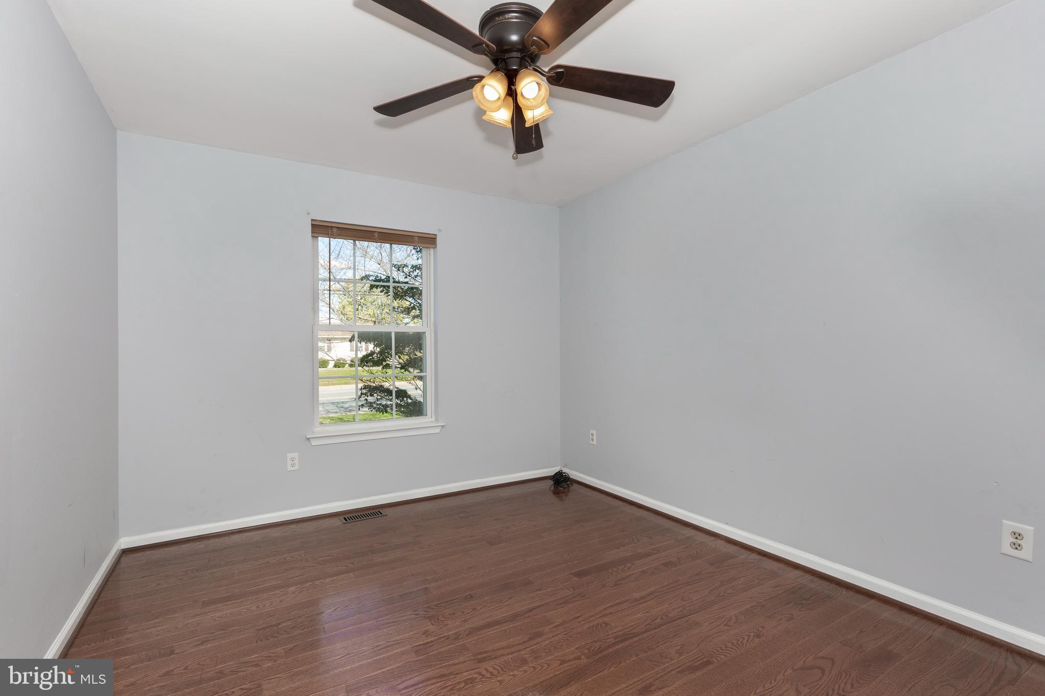 703 Uniontown Road Westminster, MD 21158 - Photo 15 of 42 wooden floor in an empty room with a window