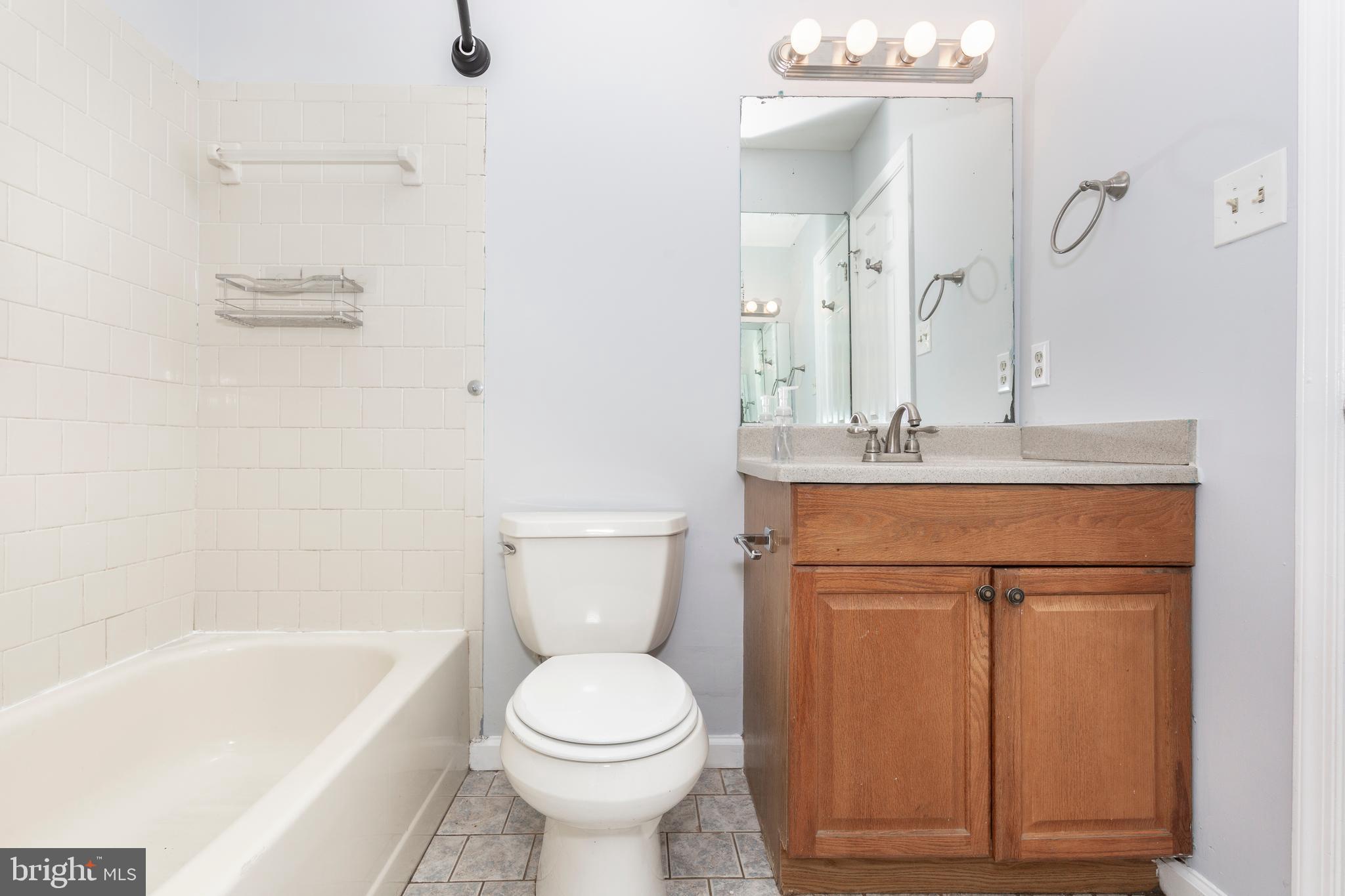 703 Uniontown Road Westminster, MD 21158 - Photo 21 of 42 a bathroom with a sink a toilet and shower