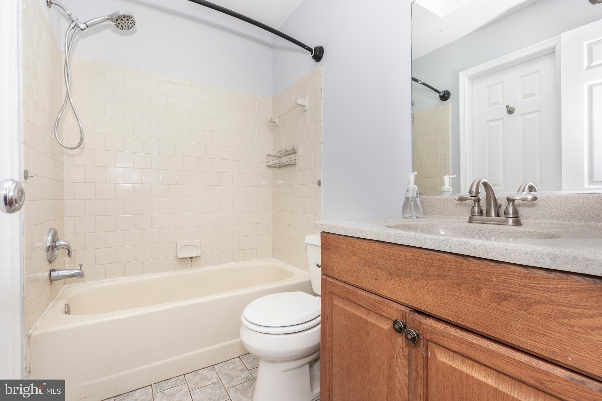 703 Uniontown Road Westminster, MD 21158 - Photo 22 of 42 a bathroom with a granite countertop sink a toilet and shower