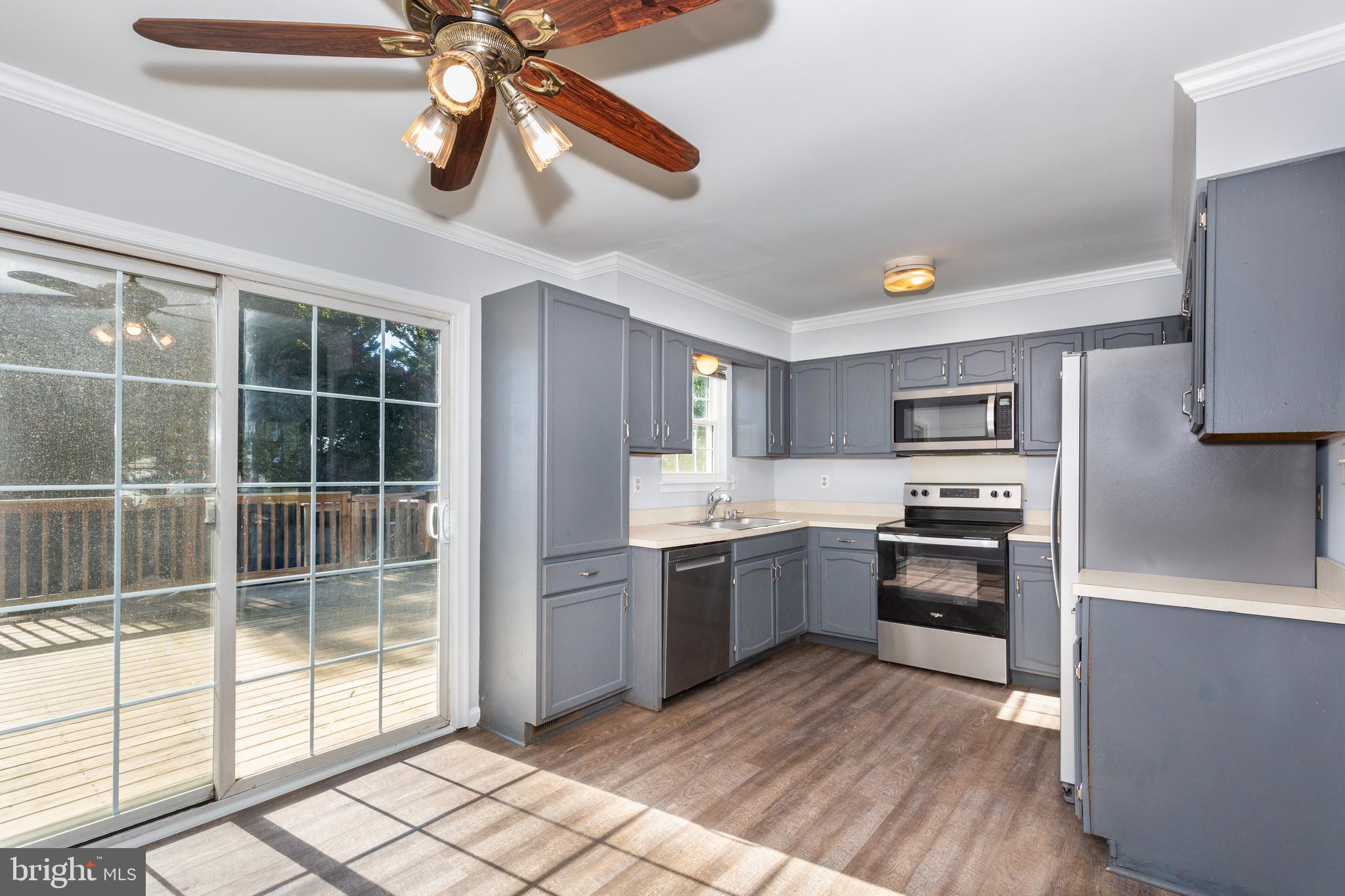 703 Uniontown Road Westminster, MD 21158 - Photo 3 of 42 a kitchen with stainless steel appliances granite countertop a stove and a refrigerator