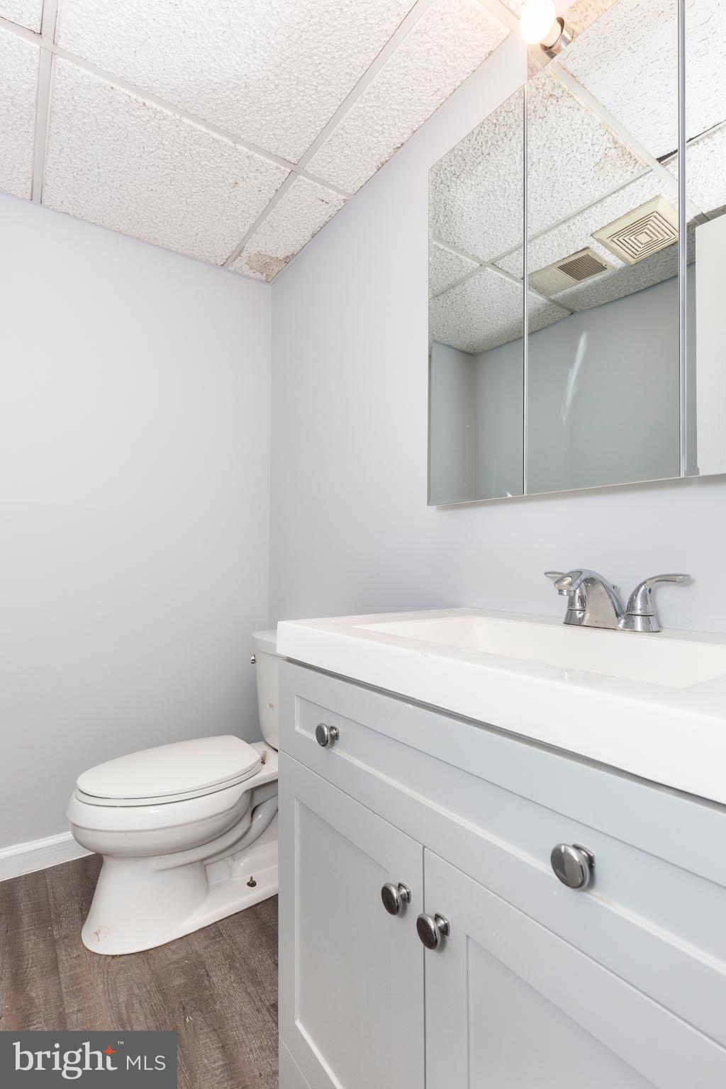703 Uniontown Road Westminster, MD 21158 - Photo 35 of 42 a bathroom with a sink a toilet and vanity