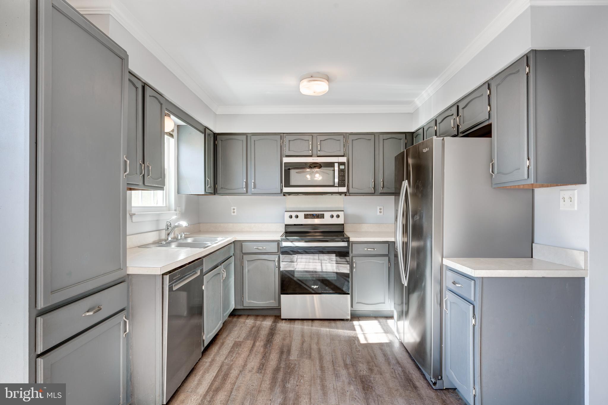 703 Uniontown Road Westminster, MD 21158 - Photo 4 of 42 a kitchen with granite countertop a refrigerator stove and sink
