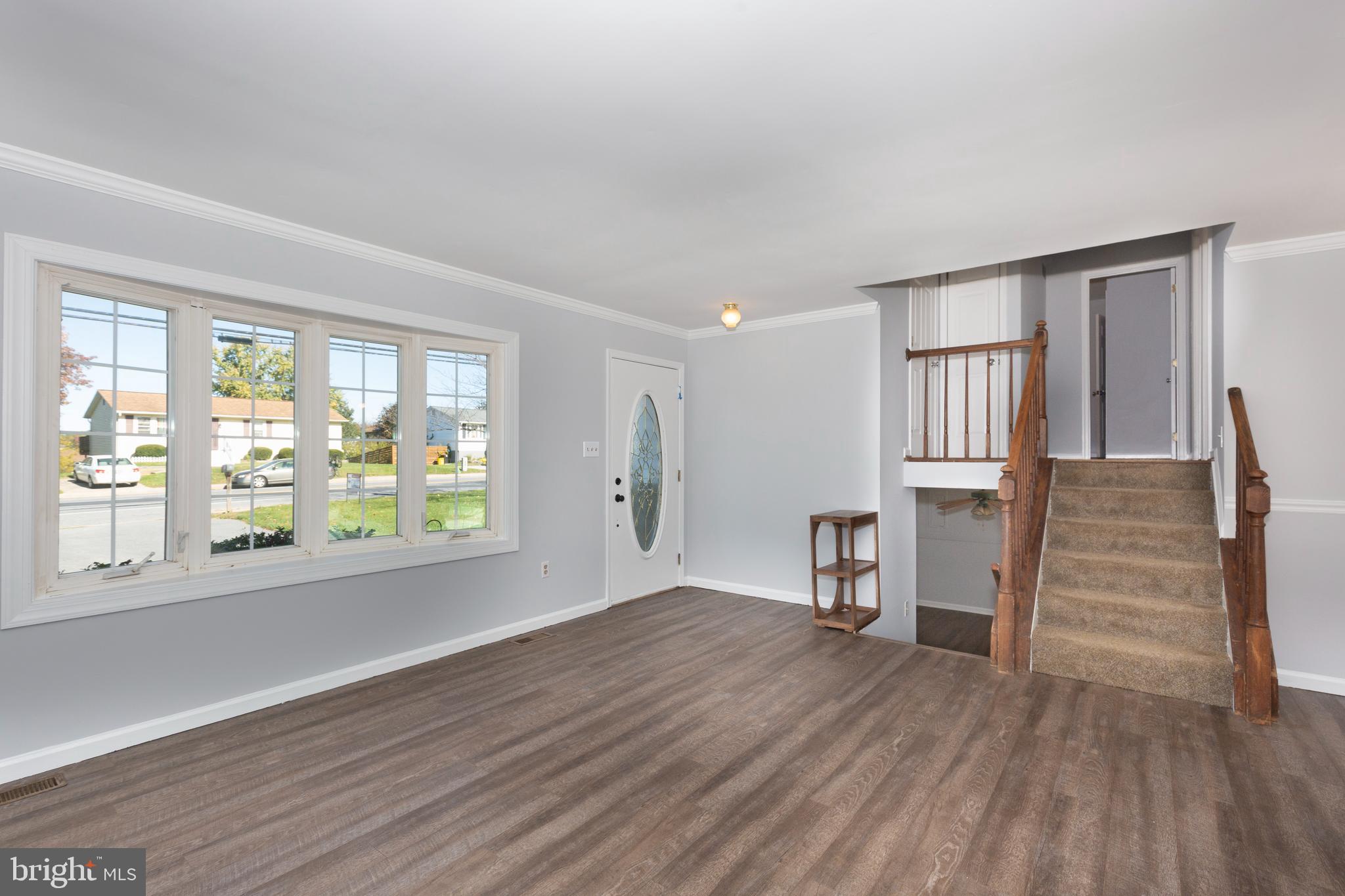 703 Uniontown Road Westminster, MD 21158 - Photo 6 of 42 wooden floor in an empty room with a window