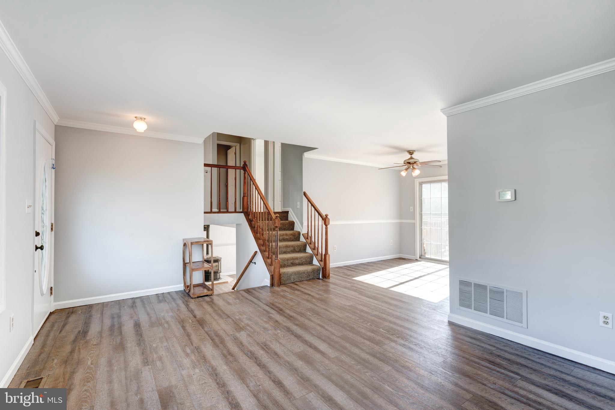 703 Uniontown Road Westminster, MD 21158 - Photo 7 of 42 a view of a hallway with wooden floor and stairs