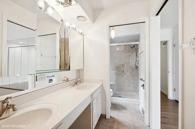a bathroom with a double vanity sink mirror double shower and a bathtub