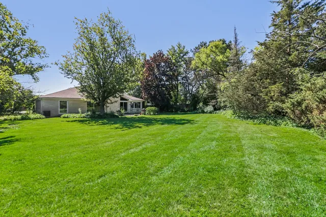 a view of an house with backyard space and garden