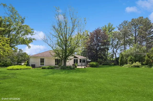 a front view of house with a garden