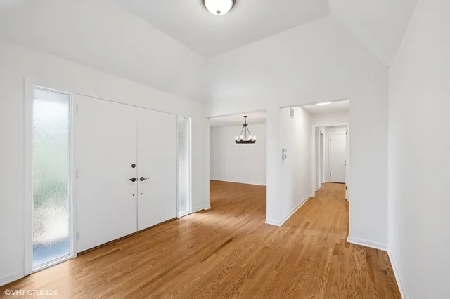 a view of hallway with wooden floor
