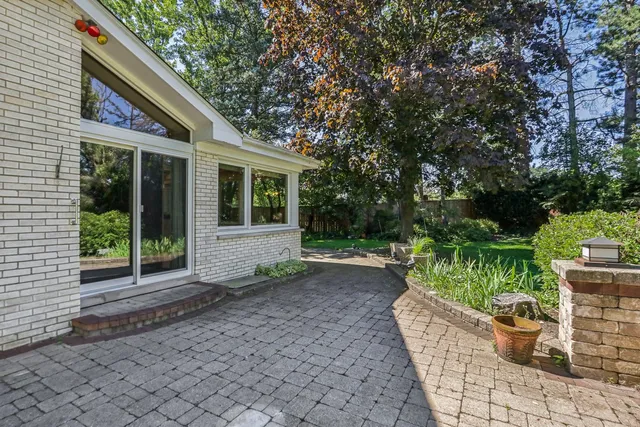 a view of a house with backyard sitting area and garden