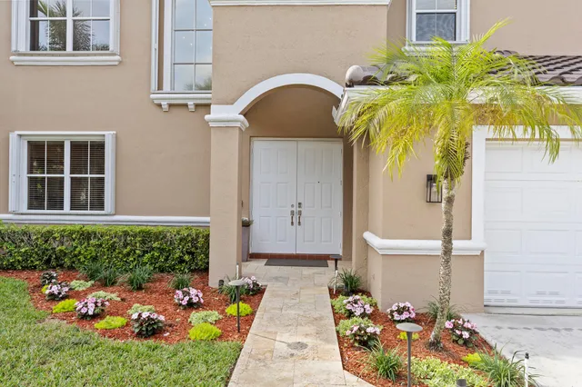 a view of a hallway to a livingroom with furniture