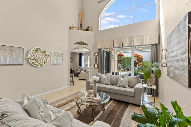 a dining room with furniture a chandelier and wooden floor