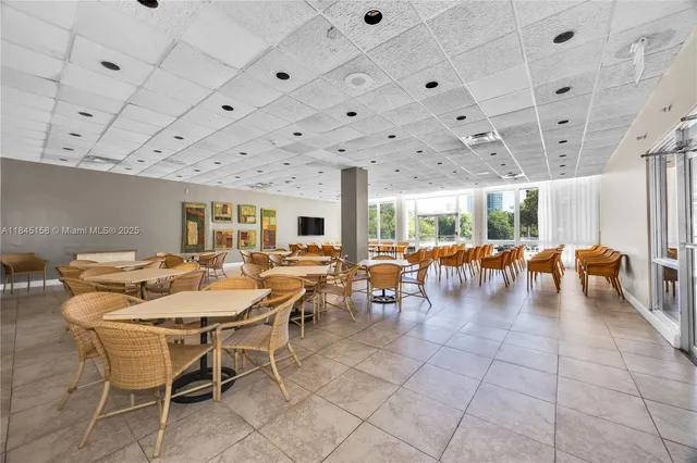 a dining hall with lots of tables and chairs
