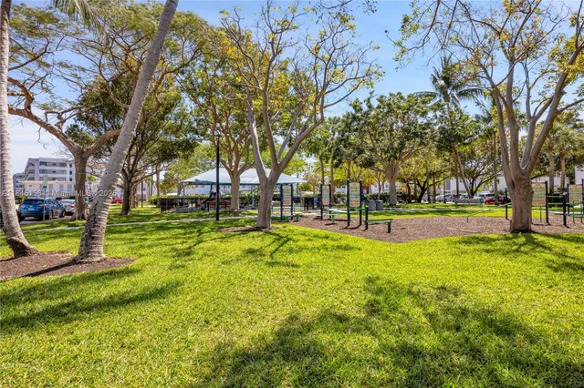 a view of swimming pool with trees and wooden fence