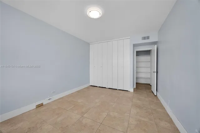 a view of an empty room and a window