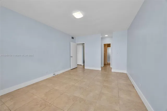 an empty room with windows and closet