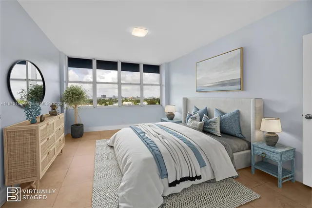 a bedroom with a large bed and a large window