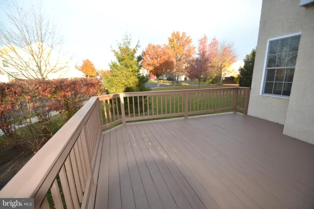 a view of balcony with wooden floor and fence