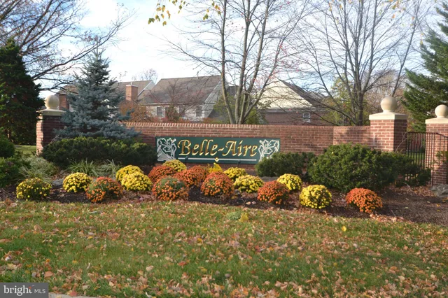 a view of a sign that is sitting in the middle of forest