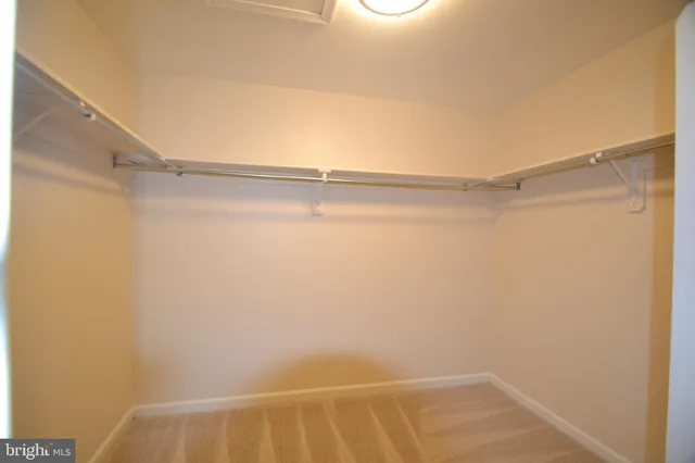 a view of an empty room with a ceiling fan