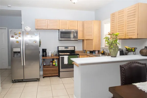 a kitchen with stainless steel appliances a refrigerator sink and microwave