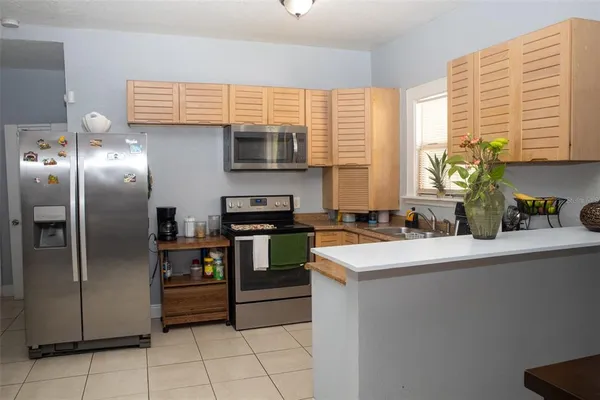 a kitchen with stainless steel appliances a sink stove and refrigerator