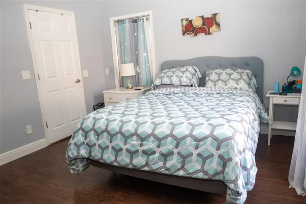 a large bed sitting in a bedroom next to a window