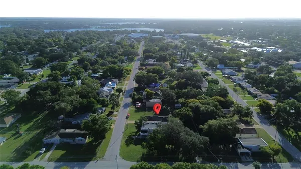 an aerial view of residential house with green space