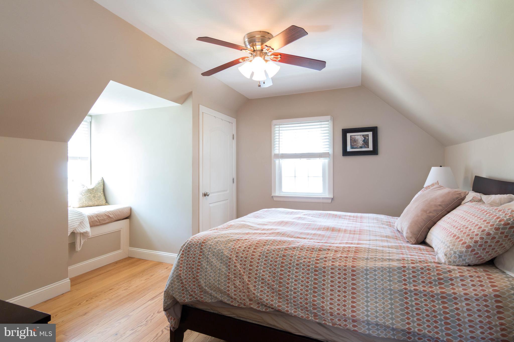 1234 Oakland Terrace Road Baltimore, MD 21227 - Photo 16 of 30 a bedroom with a large bed and a chandelier