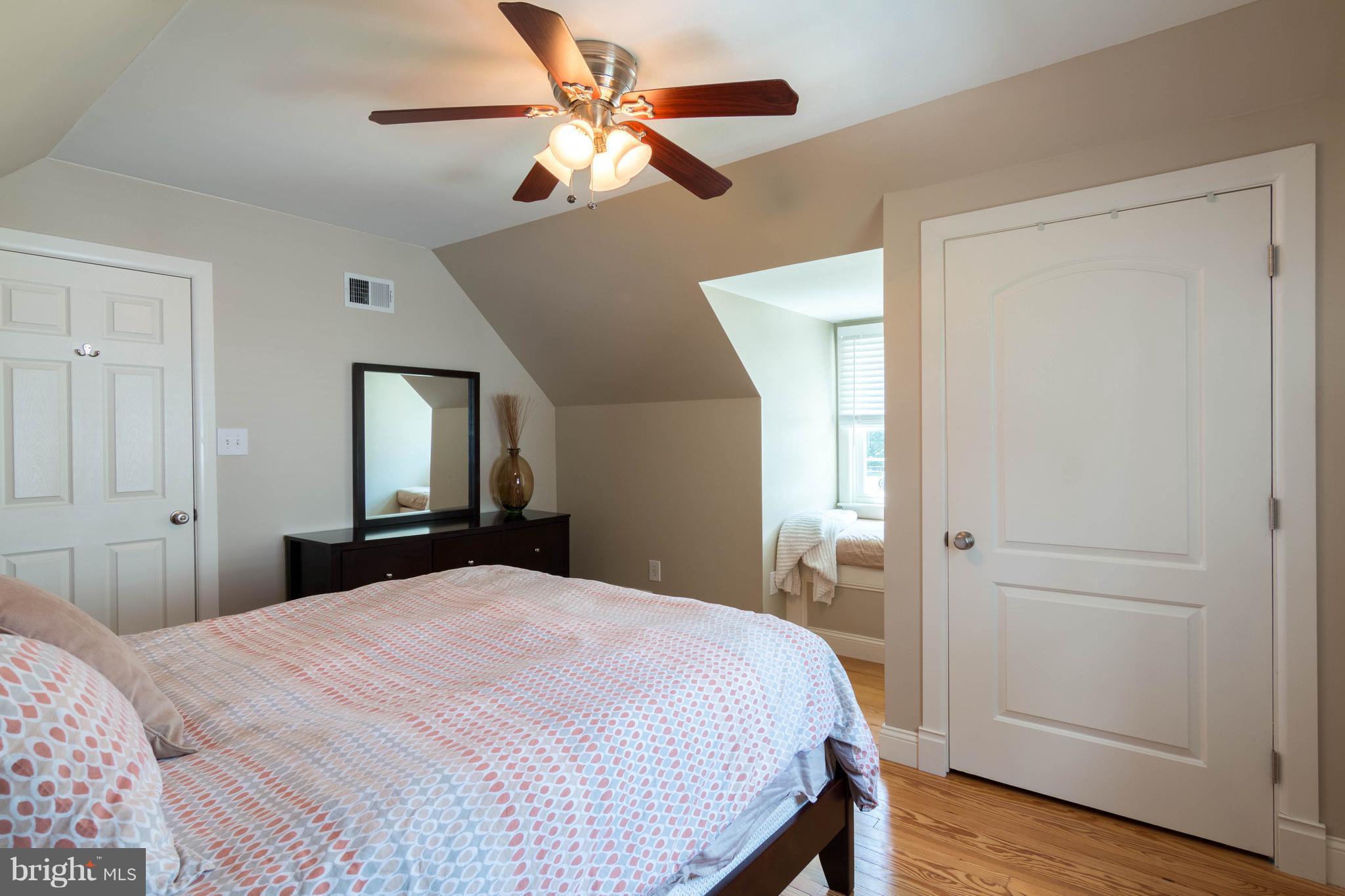 1234 Oakland Terrace Road Baltimore, MD 21227 - Photo 17 of 30 a bedroom with a large bed chandelier and a window