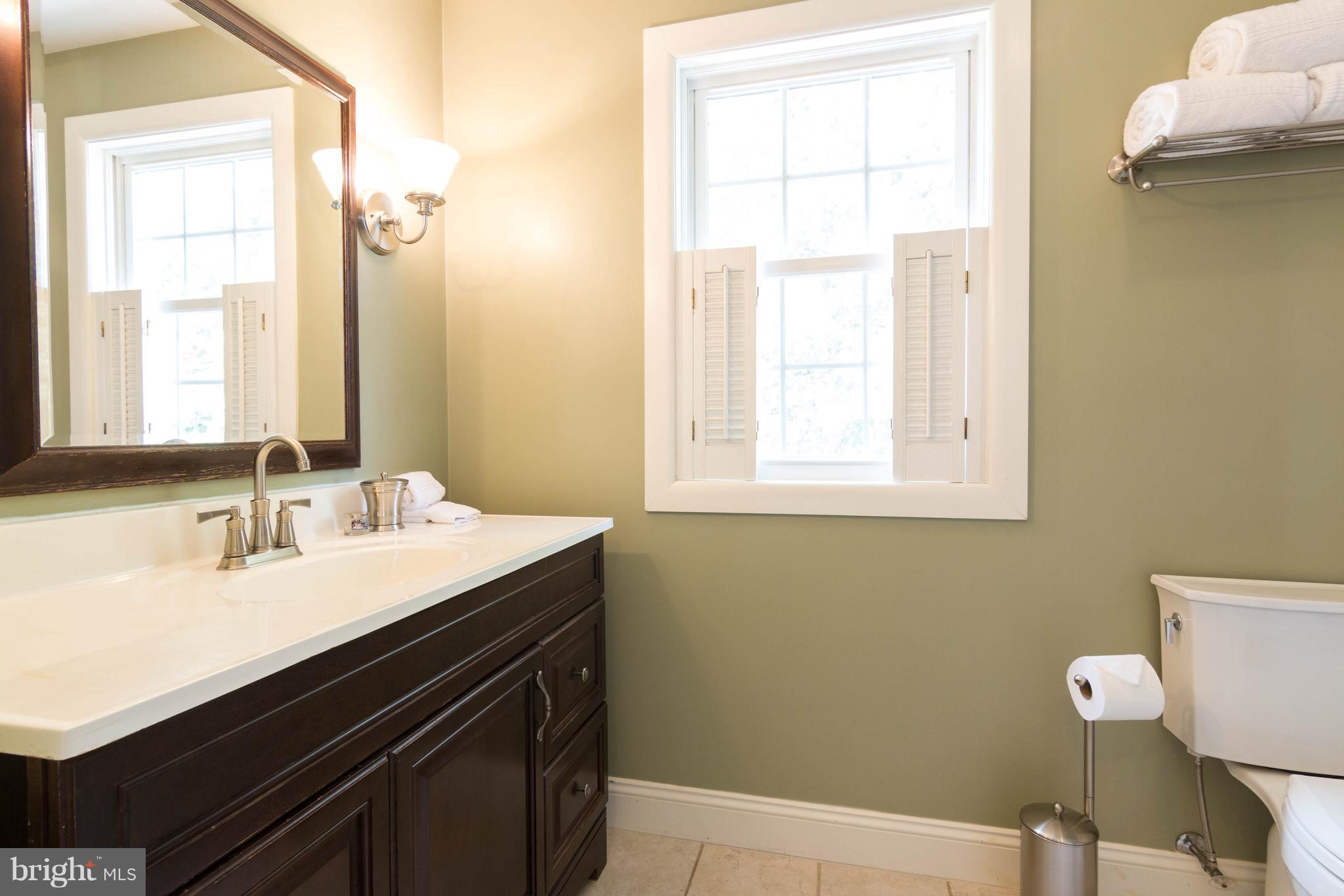 1234 Oakland Terrace Road Baltimore, MD 21227 - Photo 18 of 30 a bathroom with a sink a vanity and a bathtub