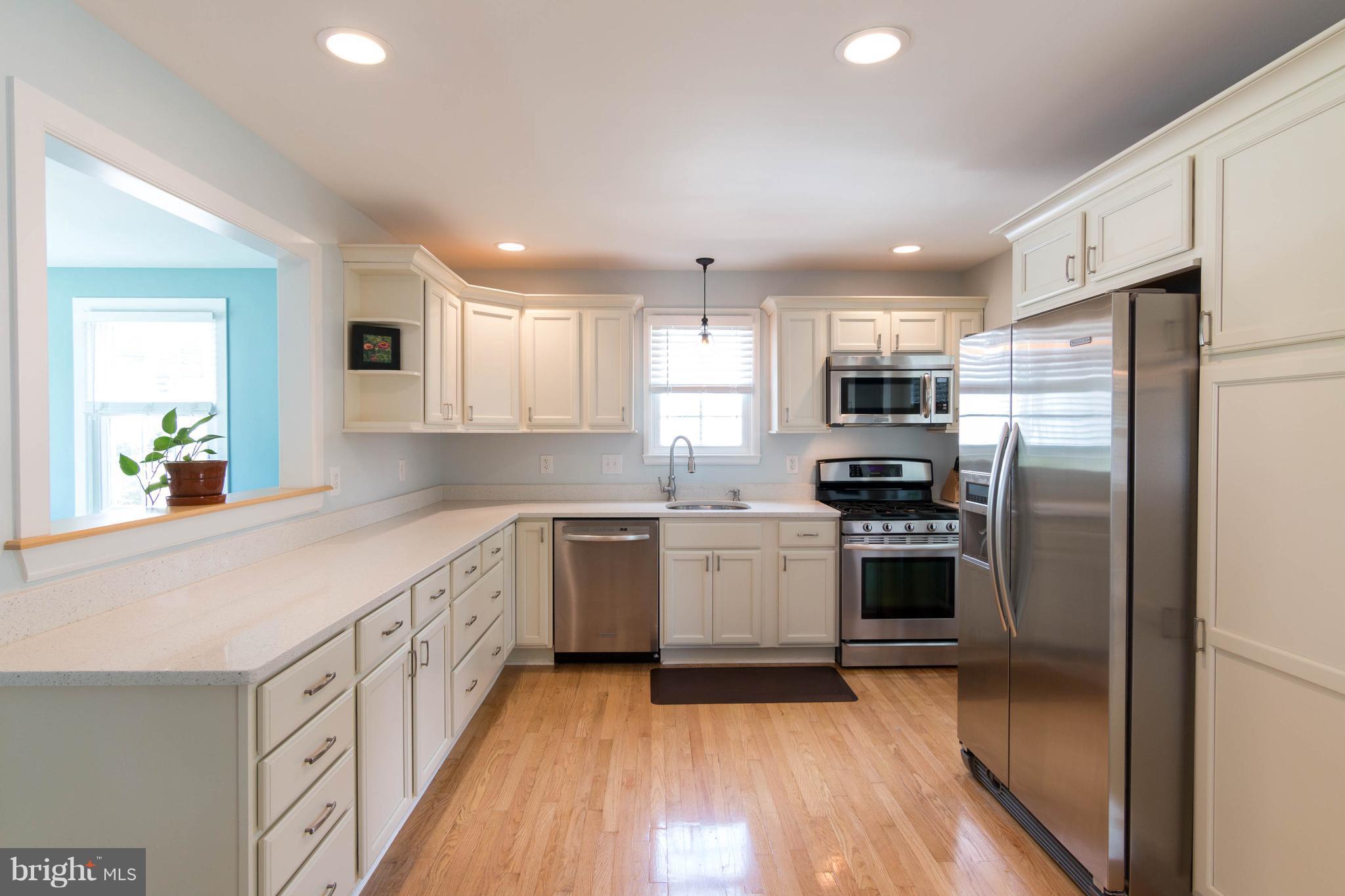 1234 Oakland Terrace Road Baltimore, MD 21227 - Photo 5 of 30 a kitchen with granite countertop a refrigerator stove top oven and sink