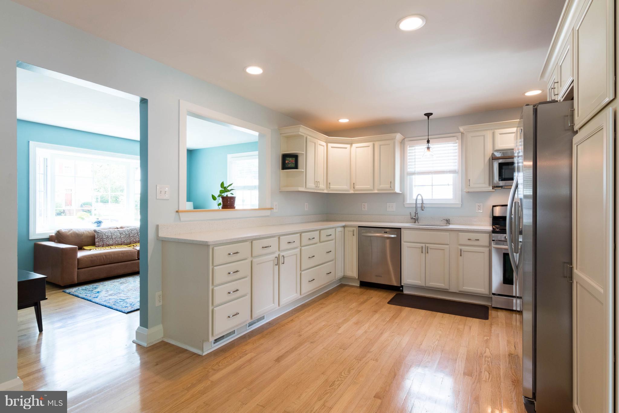 1234 Oakland Terrace Road Baltimore, MD 21227 - Photo 6 of 30 a kitchen with white cabinets and white appliances