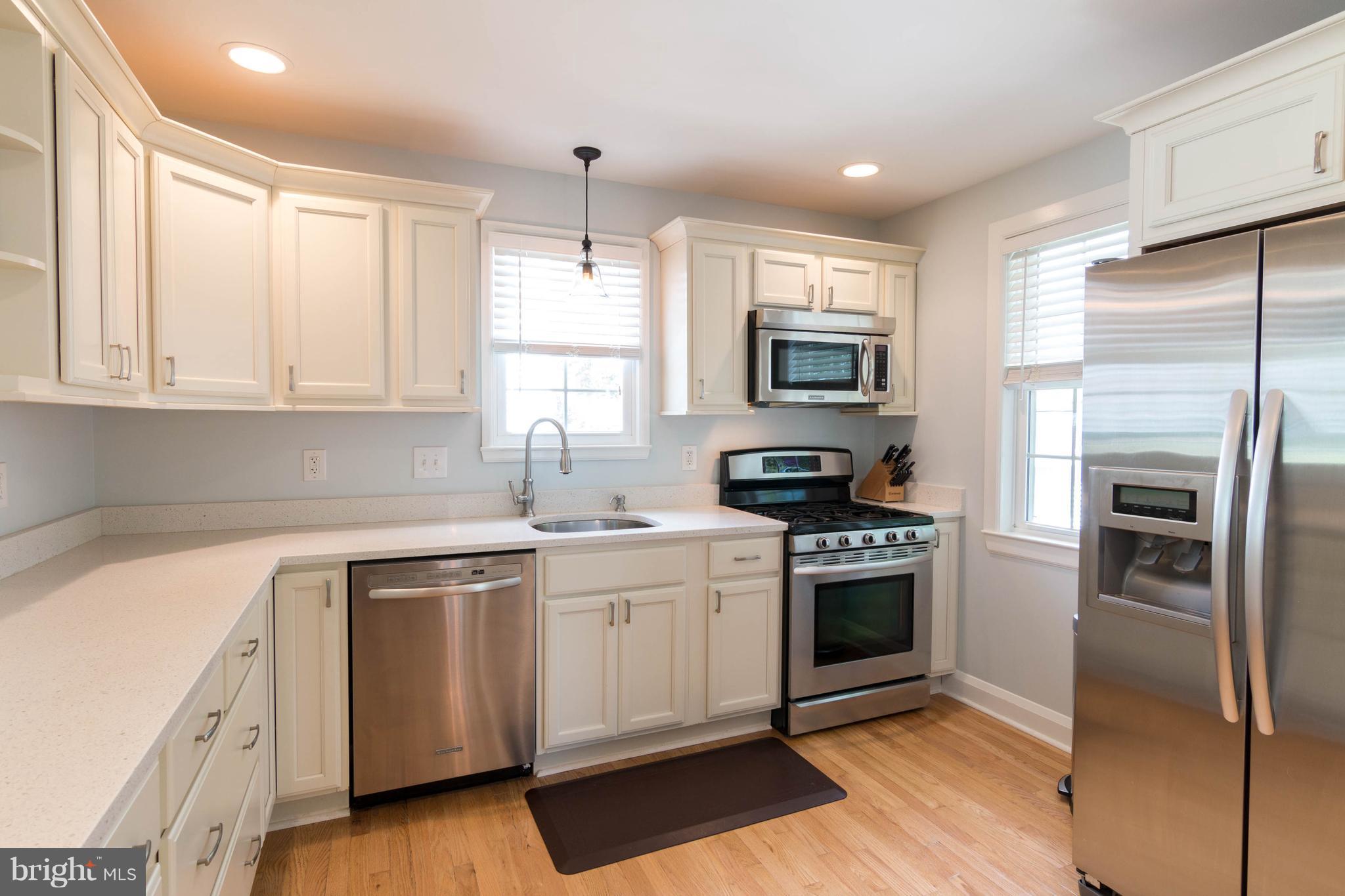 1234 Oakland Terrace Road Baltimore, MD 21227 - Photo 7 of 30 a kitchen with a sink stove and microwave