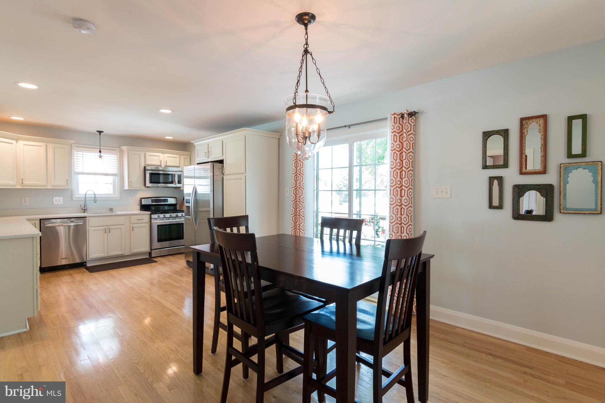 1234 Oakland Terrace Road Baltimore, MD 21227 - Photo 9 of 30 a view of a dining room with furniture window and wooden floor