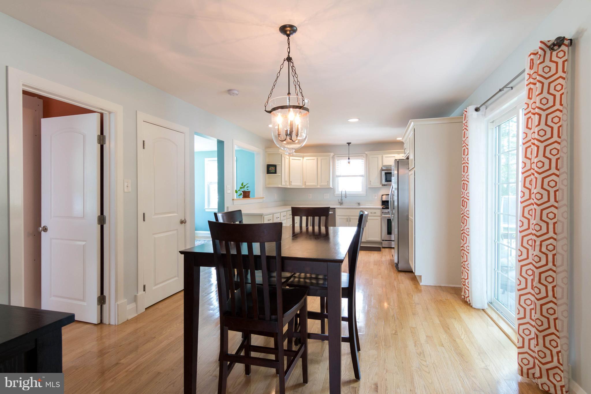 1234 Oakland Terrace Road Baltimore, MD 21227 - Photo 10 of 30 a view of a dining room and livingroom with furniture wooden floor a chandelier