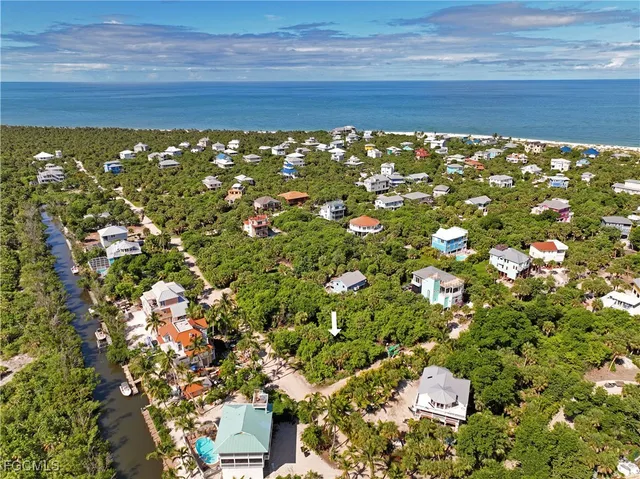 an aerial view of a residential houses with yard
