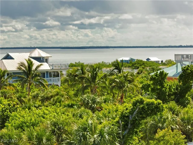 a terrace with a bench and lake view