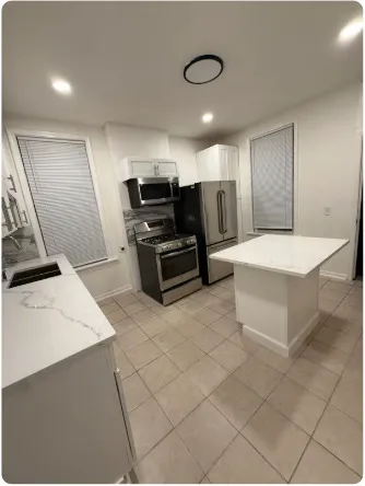 a large kitchen with a sink and a stove top oven